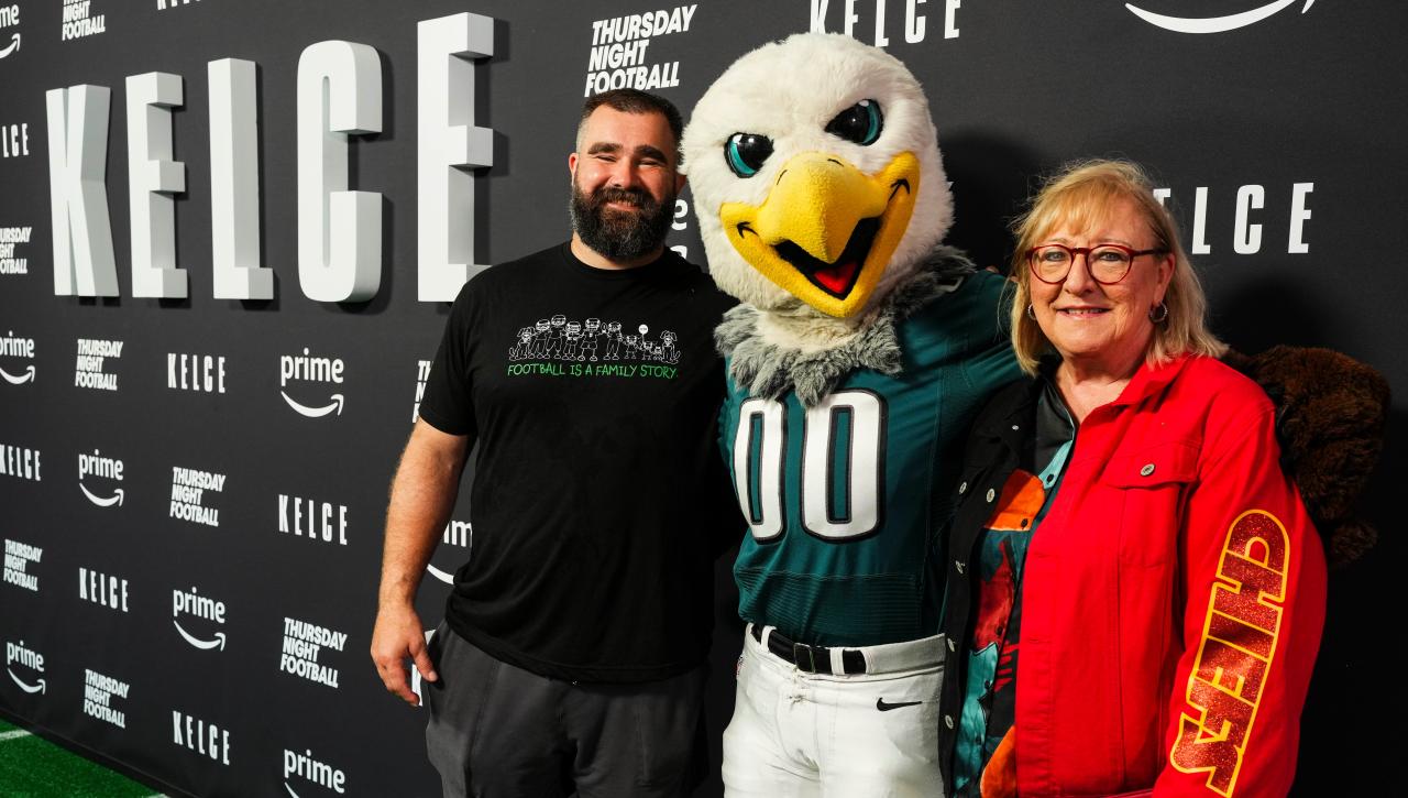 Donna Kelce poses next to the Philadelphia Eagles mascot and son Jason Kelce