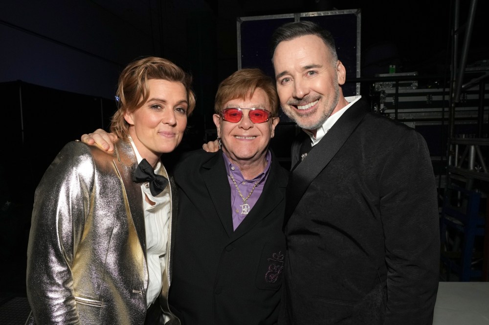LOS ANGELES, CALIFORNIA - FEBRUARY 03: (L-R) Brandi Carlile, Elton John, and David Furnish attend MusiCares Persons of the Year Honoring Berry Gordy and Smokey Robinson at Los Angeles Convention Center on February 03, 2023 in Los Angeles, California. (Photo by Kevin Mazur/Getty Images for The Recording Academy)